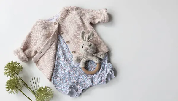 Baby clothes set top view.Beautiful infant outfit. Cardigan and romper. Organic clothing. Child\'s apparel.