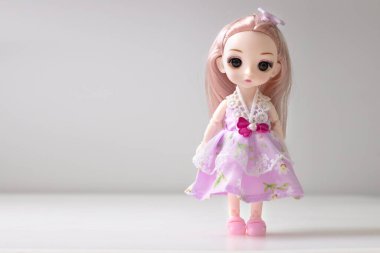 Beyaz Emty Space arka planında duran tek bir bebek. Oyuncak kız. İnsan..