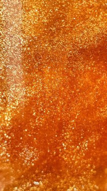 Işıl ışıl taneleri olan parlak altın bir doku.