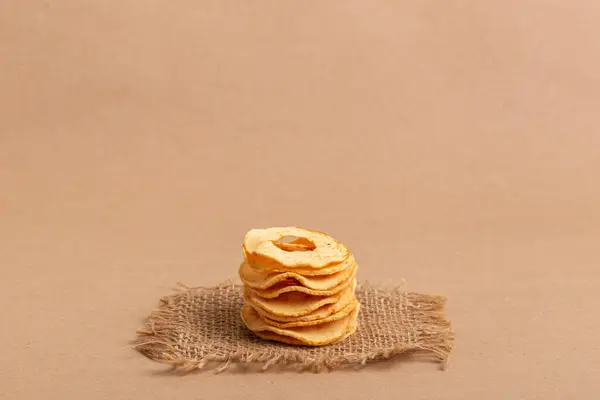 stock image Healthy snack. Apple chips on a beige background.