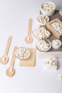 D3 vitamini, a, e, b, c vitamini, balık yağı, magnezyum, çinko ve kalsiyum gibi organik besin takviyeleri, mineraller ve vitaminler yukarıdan beyaz zemin üzerinde güzel kompozisyonda. Bir sürü hap ve farklı tabletler..