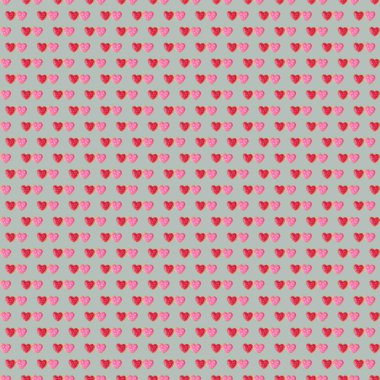 Pattern of pair of red and pink heart shaped royal icing cookies on cloud gray background