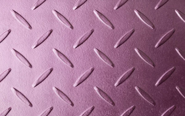 Top view of metallic mauve colored metal flooring surface texture