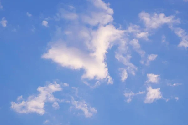 Fantastic natural flying bird shaped white clouds flowing on vibrant blue sky