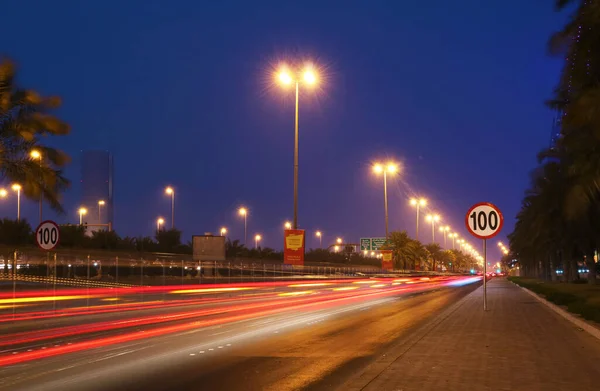 stock image Urban street in the city at night with vivid color car light trails