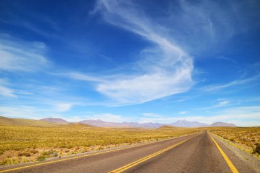 Empty Desert Road in the Los Flamencos National Reserve, Antofagasta Region, Northern Chile, South America clipart