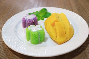 Plate of Delectable Sticky Rice with Fresh Ripe Mango, One of the Well known Thai Desserts clipart