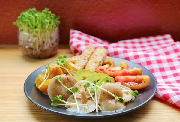 stock image Steamed Oyster Mushrooms and Colorful Vegetables Salad Garnished with Kaiware Daikon Microgreens