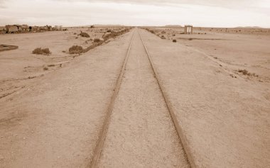 Sepia Image of Empty Old Railway Line in a Desert clipart