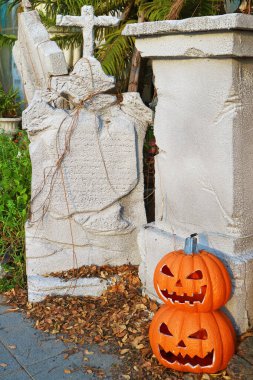 Spooky Halloween Home Decor with Tombstones and  Jack-O'-lantern Pumpkins clipart