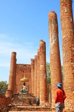 People visiting the Massive Vihara Ruins of Wat Thammikarat Ancient Buddhist Temple, Ayutthaya Historical Park, Thailand clipart