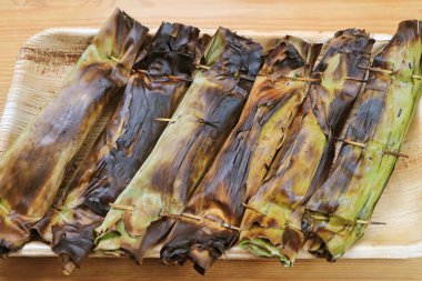 Kömürlü ızgara Tayland Tatlandırılmış Yapışkan Pilav ve sarılı muz Yaprağına Khao Niao Ping