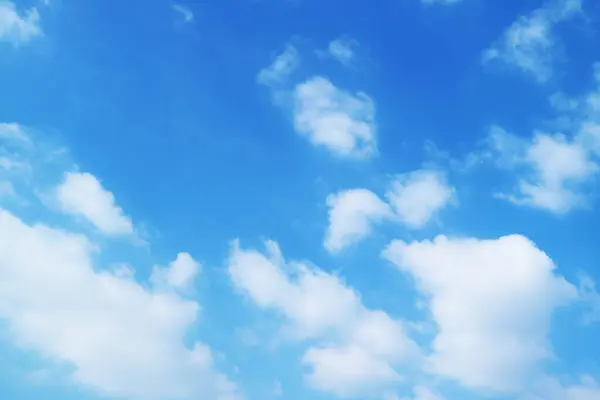 Fluffy Pure White Clouds Spreading across Vibrant Blue Sky