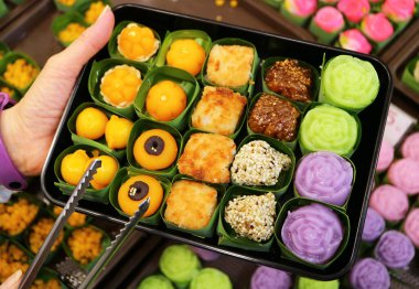 People Selecting Delectable Assorted Thai Traditional Desserts at a Sweets Shop clipart