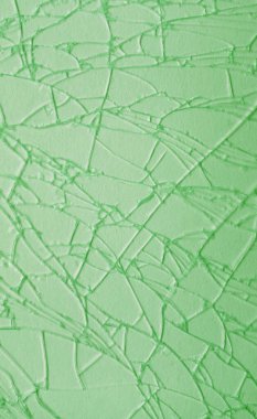 Açık yeşil çatlak cam yüzeyinin sanatsal deseni