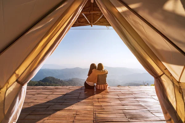 stock image Young friend looking beautiful landscape at sunset and camping on mountain, Adventure travels lifestyle concept