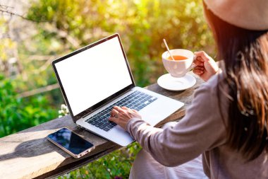 Young woman freelancer traveler working online using laptop while traveling on vacation, Freelance and workation concept clipart