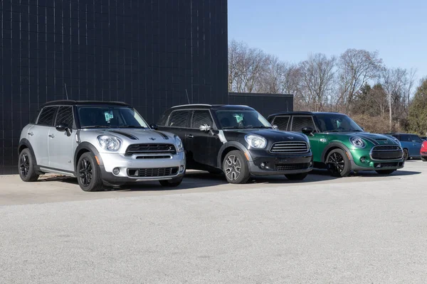 Stock image Indianapolis - Circa December 2022: Mini Hardtop vehicles awaiting service at a dealership. Mini is a subsidiary of BMW.