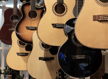 Acoustic guitar display. Guitars are six stringed musical instruments musicians have been using to write popular music for decades.