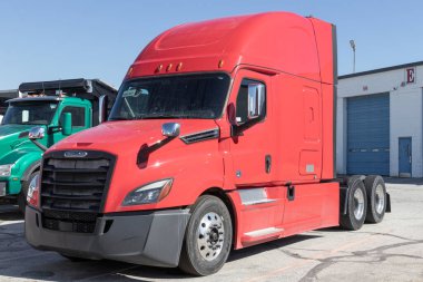 Indianapolis - Circa March 2023: Freightliner Semi Tractor Trailer Big Rig Trucks Lined up for sale. Freightliner is owned by Daimler. clipart