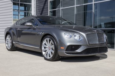 Indianapolis - Circa March 2023: Bentley Continental display at a dealership. Bentley Motors is a British manufacturer of luxury cars and SUVs. clipart