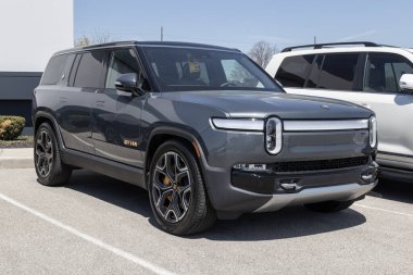 Indianapolis - Circa April 2023: Rivian R1S EV Electric Vehicle display at a dealership. Rivian offers the R1S in Adventure and Launch models. clipart