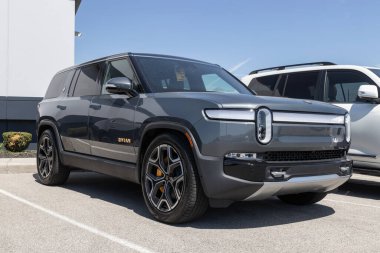 Indianapolis - Circa April 2023: Rivian R1S EV Electric Vehicle display at a dealership. Rivian offers the R1S in Adventure and Launch models. clipart