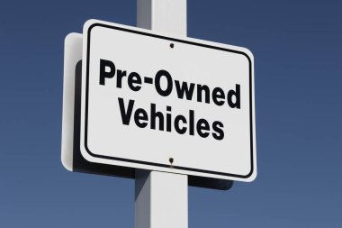 Pre-Owned Vehicle car sign at a dealership. With supply issues, used and preowned cars are in high demand. clipart