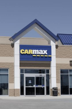 Indianapolis - April 13, 2024: CarMax Auto Dealership. CarMax is the largest used and pre-owned car retailer in the US. clipart