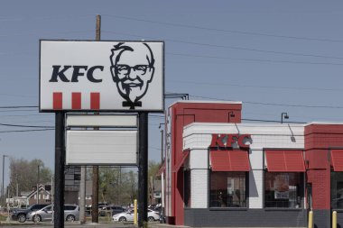 Greenwood - April 13, 2024: KFC Fried Chicken restaurant. Kentucky Fried Chicken is offering Uber and Door Dash delivery and drive thru service. clipart