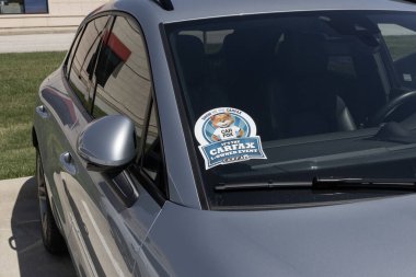 Lafayette - April 25, 2024: Carfax sticker on a used pre-owned vehicle. Carfax provides vehicle reports for prospective buyers that may reveal problems. clipart