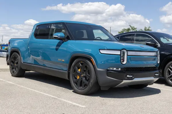 Stock image Indianapolis - May 30, 2024: Rivian R1T EV pickup truck display. Rivian offers the R1T in Adventure, Adventure All-Terrain and Launch editions. MY:2023