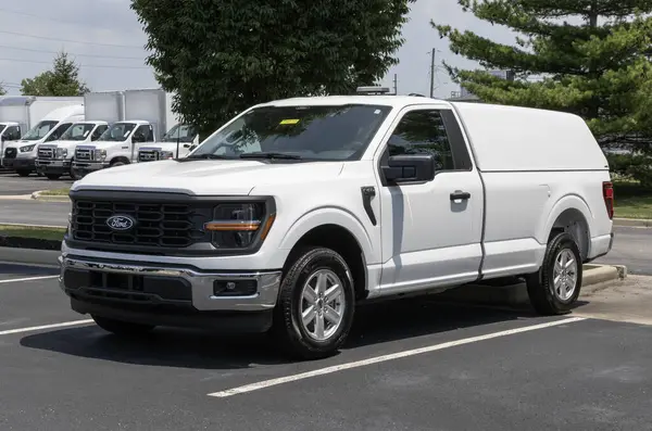 stock image Plainfield - June 16, 2024: Ford F-150 with a A.R.E. Utility Truck Shell Cap and light beacon. Ford offers the F150 in work and retail models. MY:2024