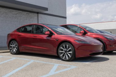 Indianapolis - August 4, 2024: Tesla Model 3 EV electric vehicle display. Select Tesla Model 3 EVs are eligible for up to a $7,500 tax credit. MY:2024 clipart