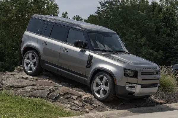 stock image Indianapolis - August 4, 2024: Land Rover Defender 110 SE display. Land Rover offers the Defender with a 493HP 5.0L V8 engine. MY:2024