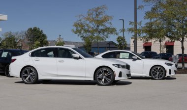 Lafayette - October 2, 2024: BMW 330i xDrive Sedan and 230i xDrive Coupe display at a dealership. BMW offers gas, hybrid and electric vehicles. MY:2024 clipart