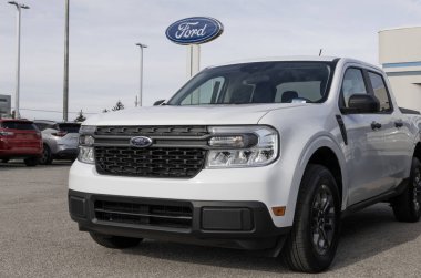 Lafayette - December 17, 2024: Ford Maverick XLT Hybrid Pickup Truck at a dealership. Ford offers the Maverick with a 2.5L Hybrid engine. MY:2024 clipart