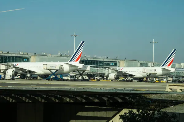 stock image 02MAR2023, CHARLES DE GAULLE Airport, Paris, France - Two Air France aircrafts parked on the tarmac for ground maintenance