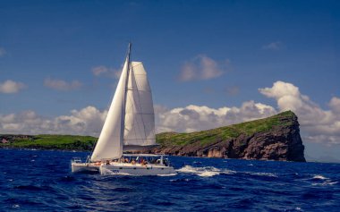 Catamaran cruise to Coin de Mire island, also called Gunners Quoin, in the North of Mauritius clipart