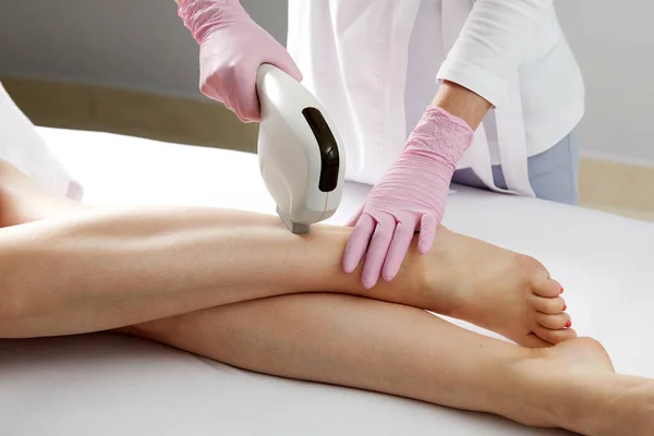 Laser hair removal on ladies legs in a beauty salon