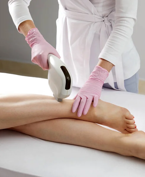 Laser hair removal on ladies legs in a beauty salon
