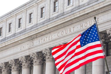 USA national flag waving in the wind in front of United States Court House in New York, USA