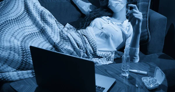 young woman on sofa covered with blanket freezing blowing running nose got fever, caught, sick girl having influenza symptoms, flu or virus concept