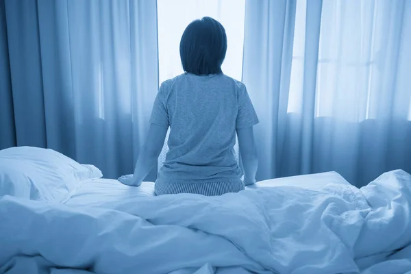 woman feel depression and sit on the bed