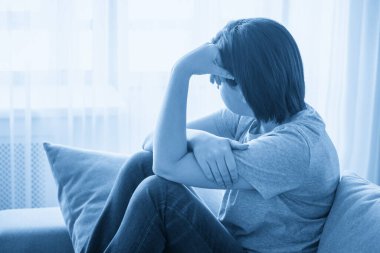 üzüntü kız evde kanepede oturuyor