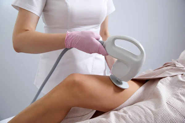 Woman is having Laser Treatment On Thigh. Ultrasound cavitation body contouring treatment. Anti cellulite treatment