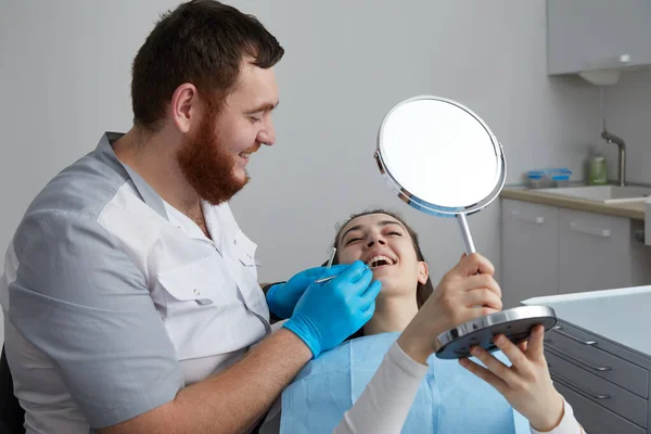 Giovane Donna Guardando Specchio Con Sorriso Ufficio Dentista — Foto Stock