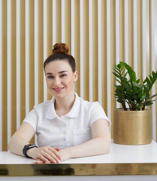 stock image Female receptionist at reception desk in modern office lobby