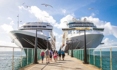 Cruise passengers return to cruise ships at St Kitts Port Zante clipart