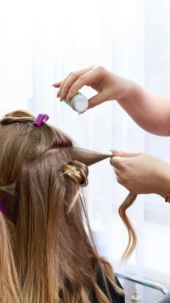 Hairdresser puts powder for volume on hair